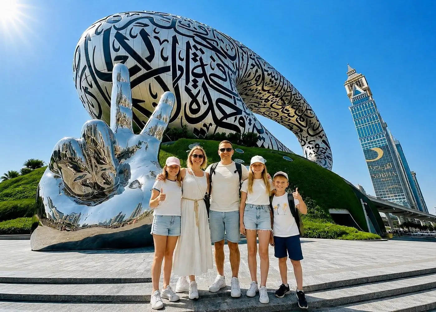 Family of five posing on the steps of the Museum of the Future in Dubai, beside the giant silver hand sculpture, on a sunny day